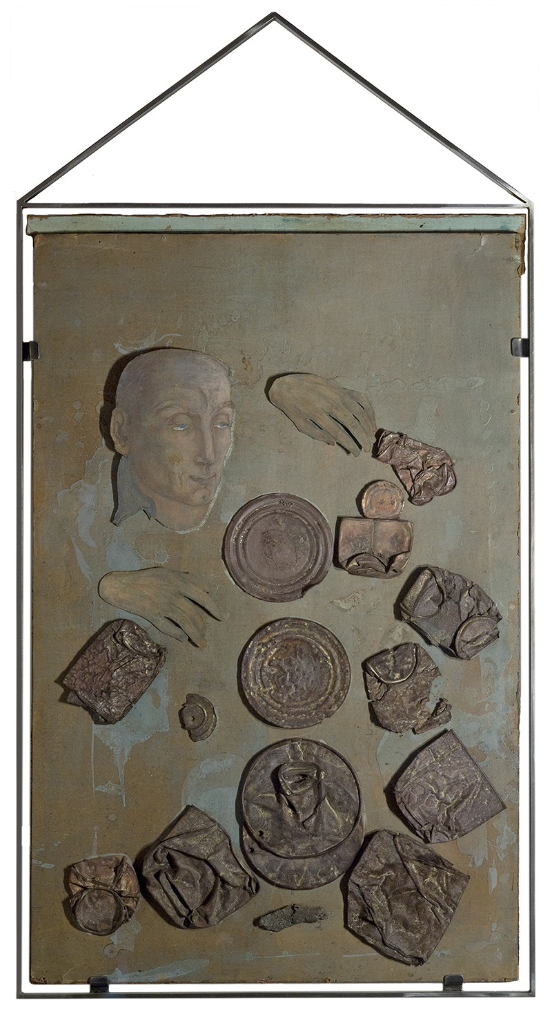 A mixed media piec whosing a mans head and various round and irregularly shaped objects
