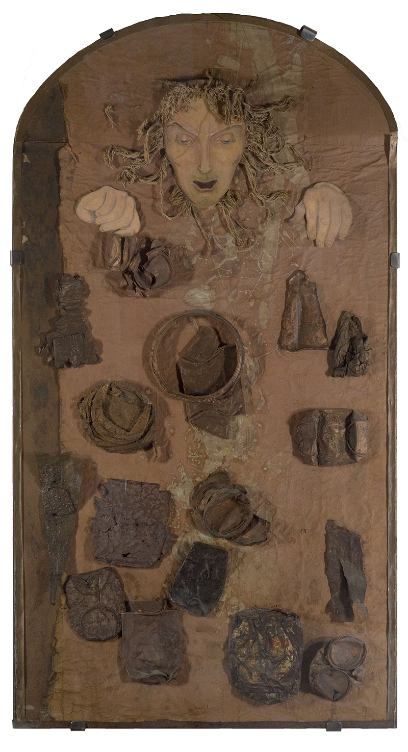 a mixed media piece with a woman's head and various irregularly shaped objects