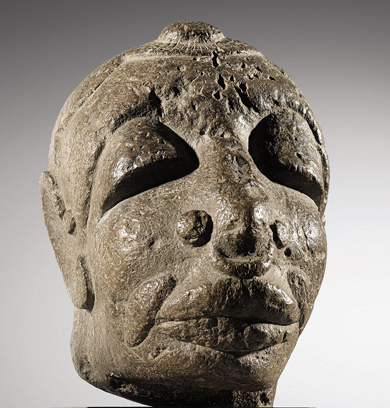 A stone sculpure of a human head