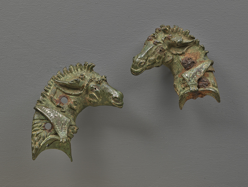 Two ancient bronze sculptures of the head of mules