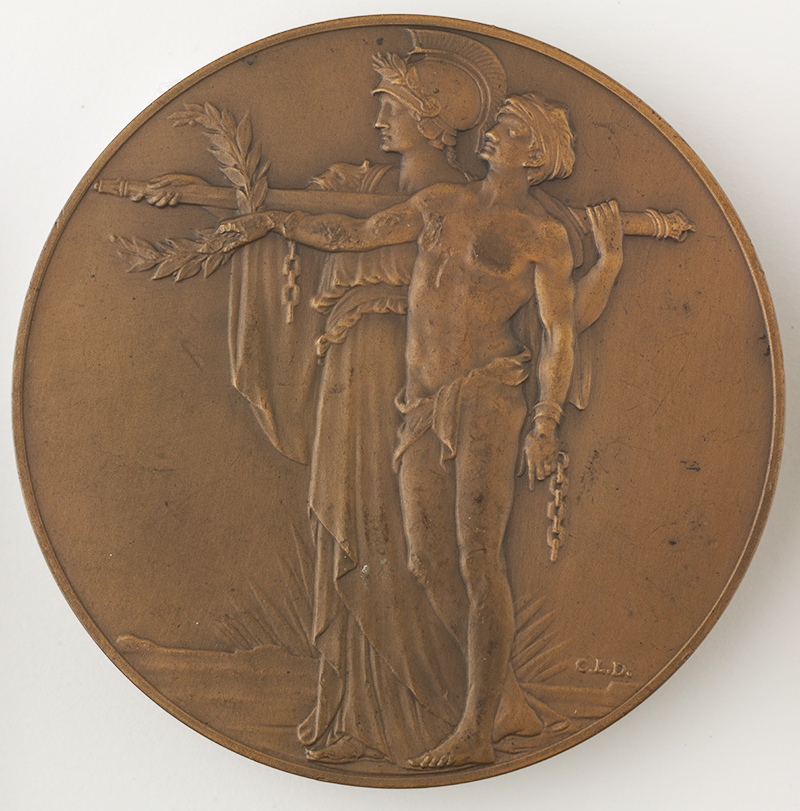 A bronze medal showing two standing figures facing left, one in a helmet, one with shackles