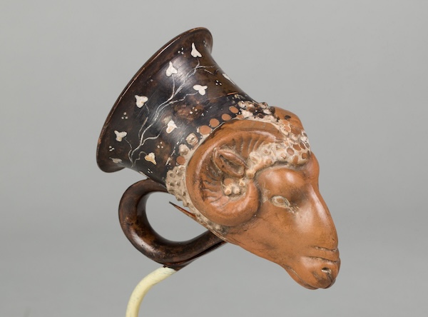 A ornate pottery vase shaped like a ram's head