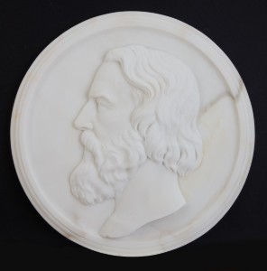 a marble relief of a bearded man facing left