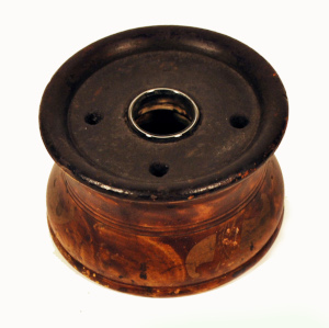 an old-fashioned inkwell with holes for pens showing at top