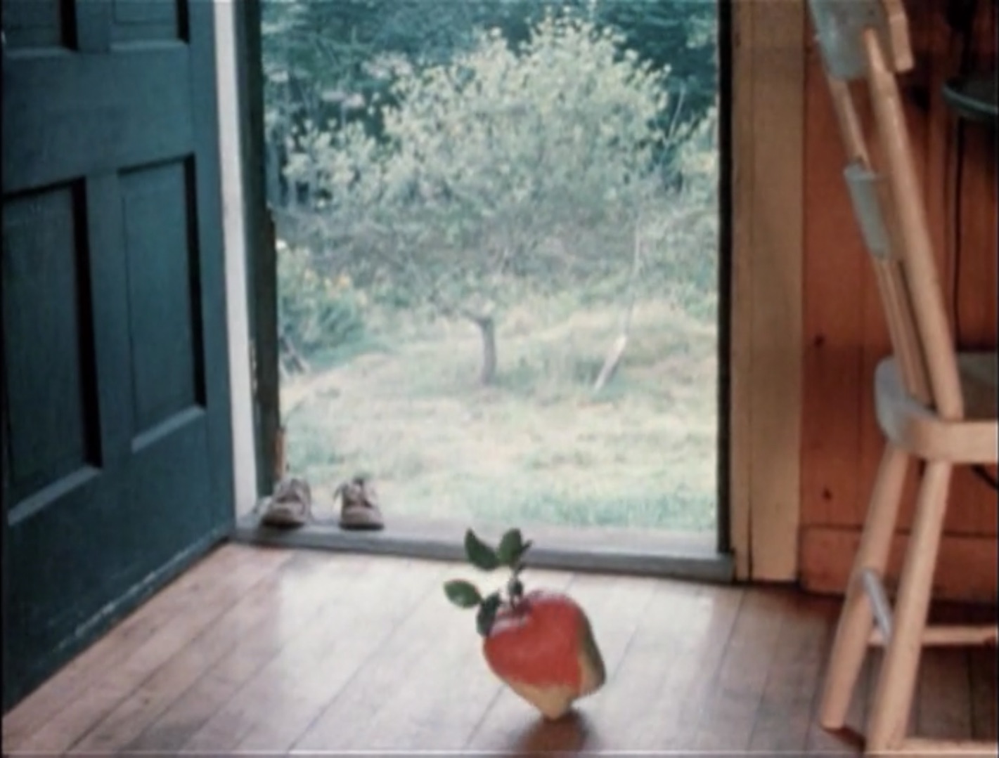 A film grab shows an apple on an interior floor