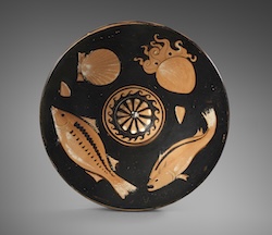An ancient clay plate with images of sea life