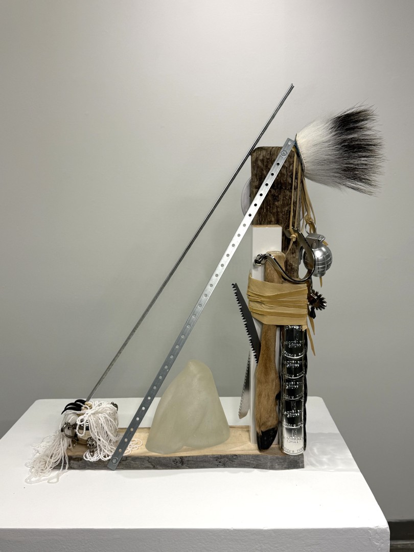 A collection of many materials forming a general triangle shape including glass, metal, hair, yarn, leather, and wood