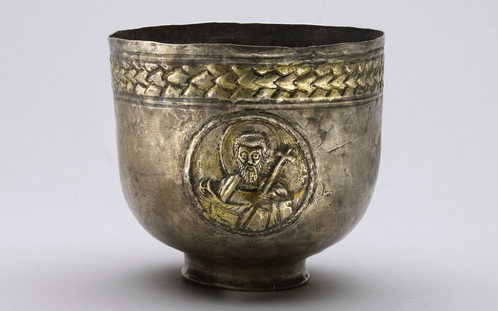 A silver chalice with the image of a saint