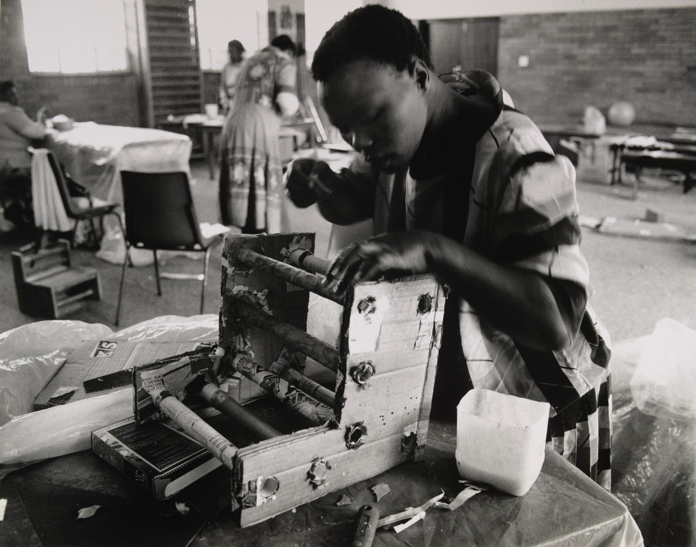 person repairing a machine on a workbench