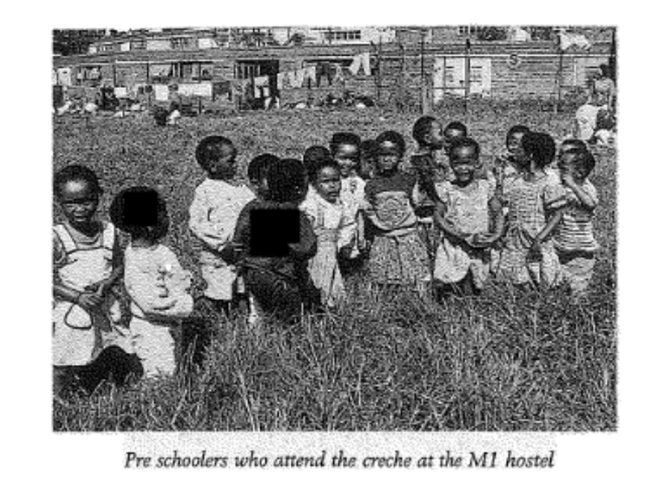 children standing in high grass in an open field