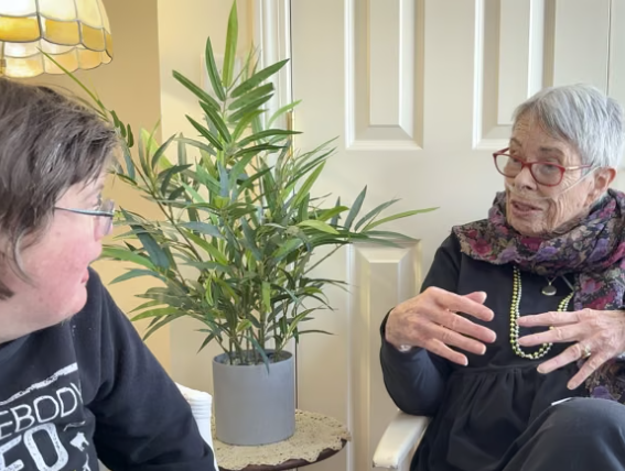 Two seated women in a conversation