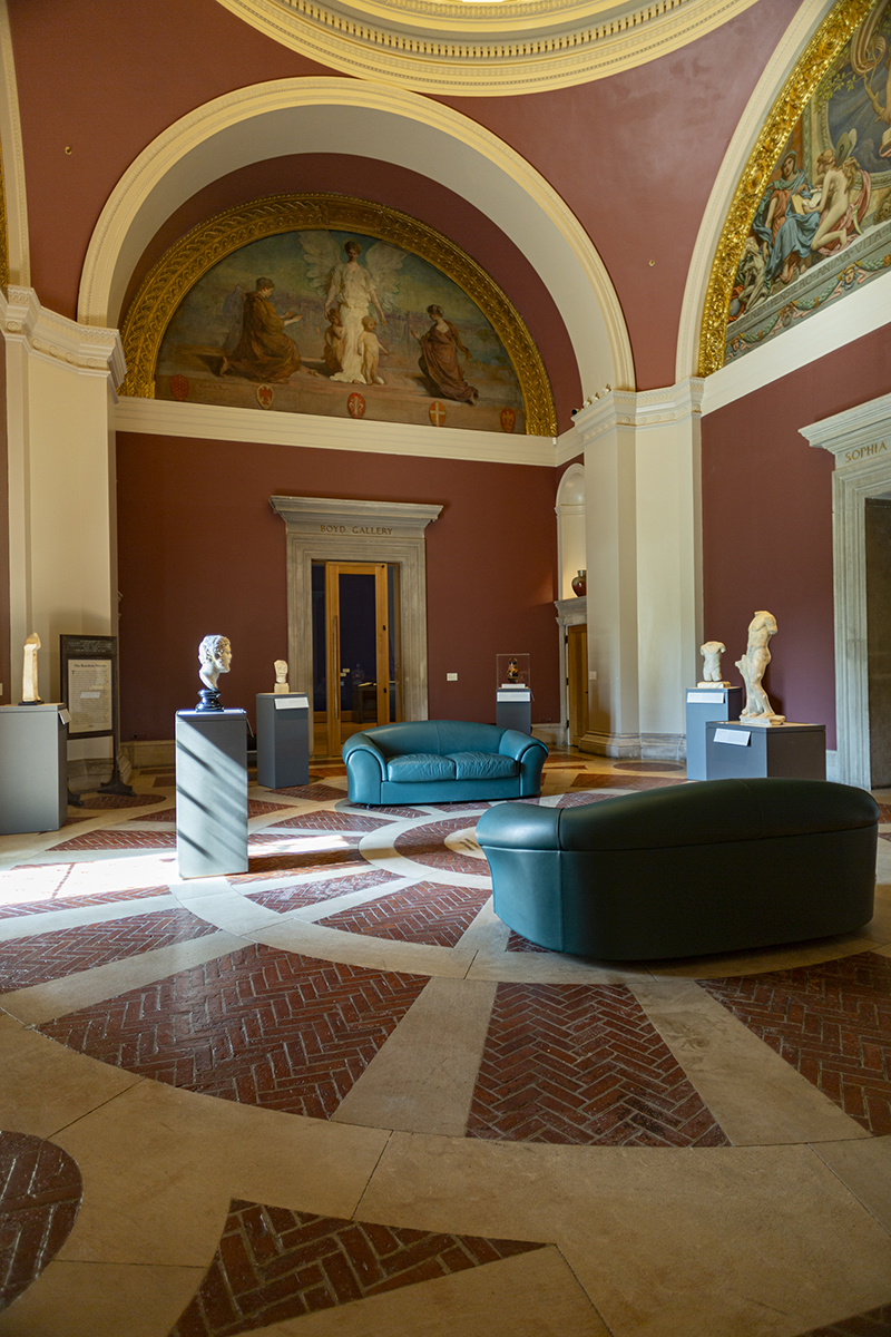 the interior of a 19th century rotunda showing ancient sculptures and lunette murals