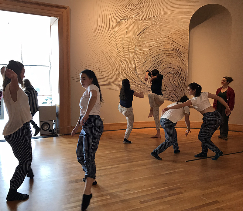 Students dancing in the exhibition "Let's Get Lost" and"Listening Glass"