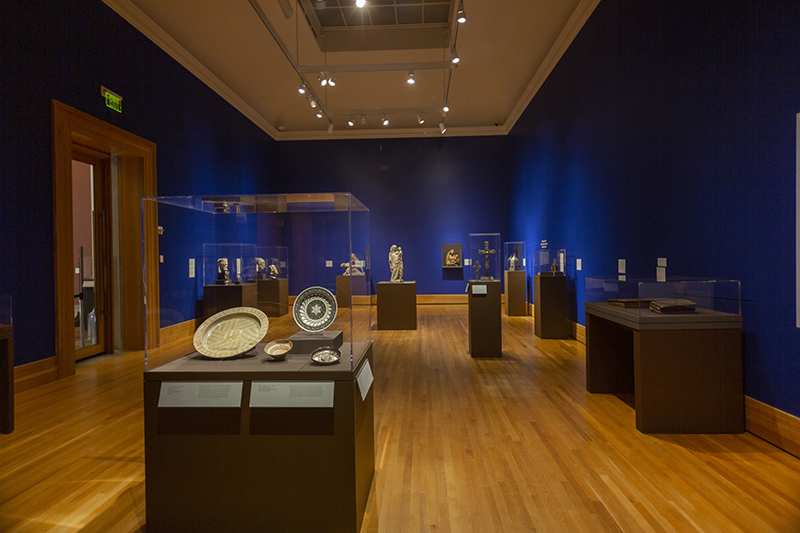 A dark blue gallery with sculptures