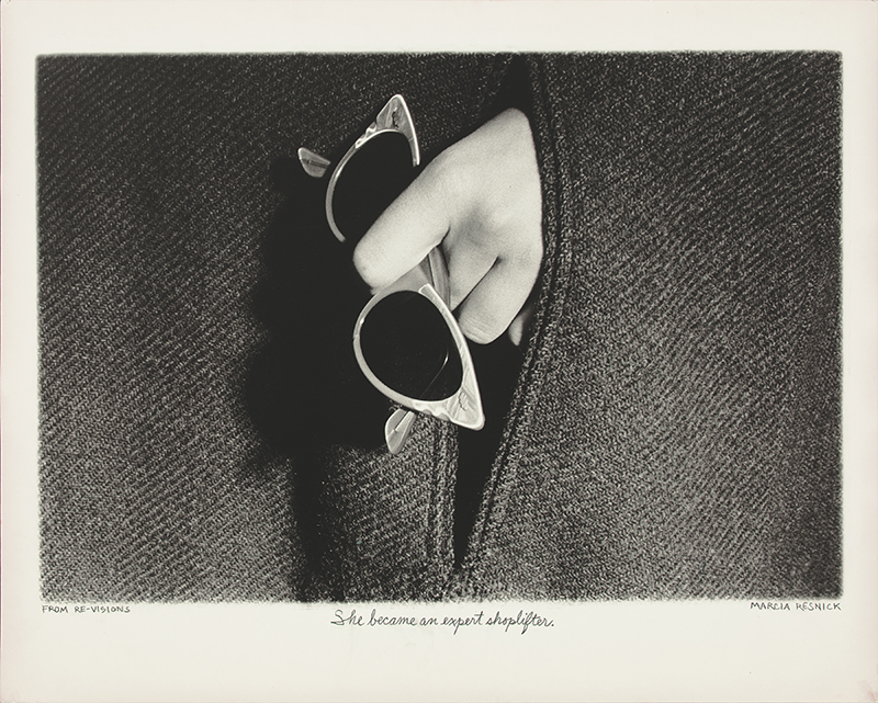 a black and white photograph of a hand holding  white frame sunglasses near the pocket of a coat