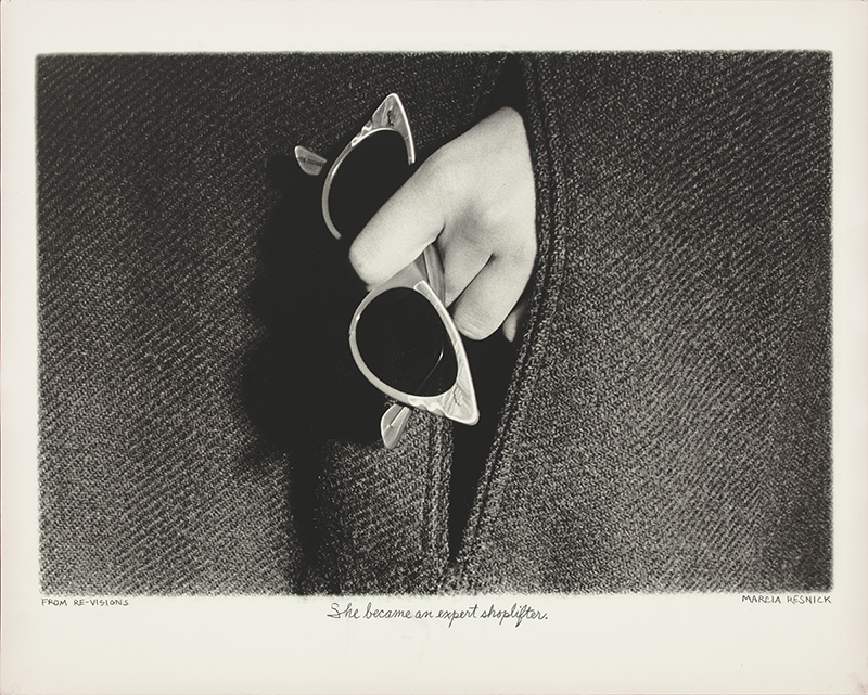 a black and white photograph of a hand holding white frame sunglasses near the pocket of a coat