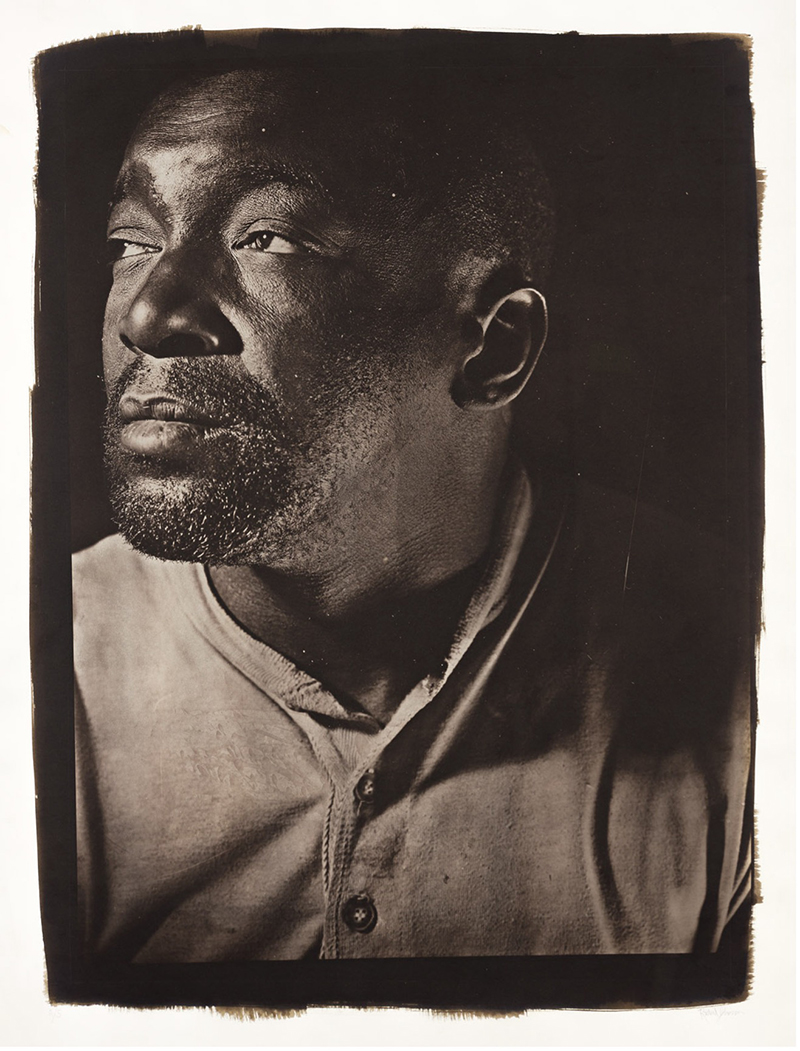 A black-and-white photograph of a man's face