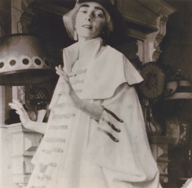 a black and white photograph of a gesturing figure in a costume