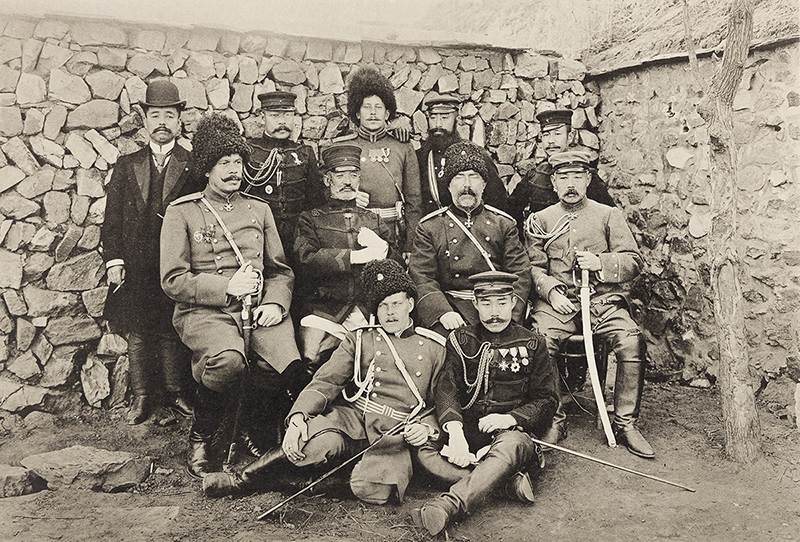 a sepia photograph showing a group of men in military garb