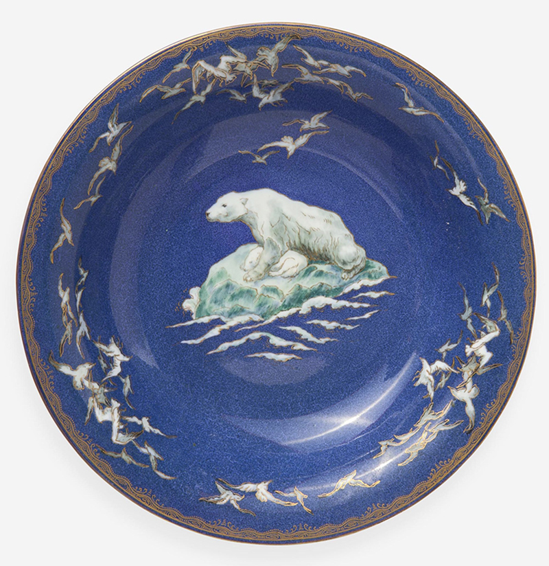 A blue circular dish with a white polar bear and cub depicted in the center