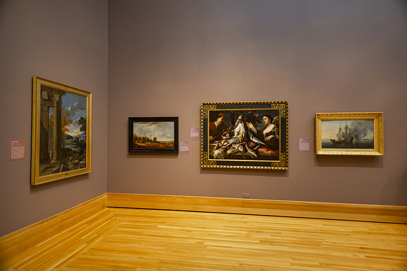 An art gallery with four paintings on the wall