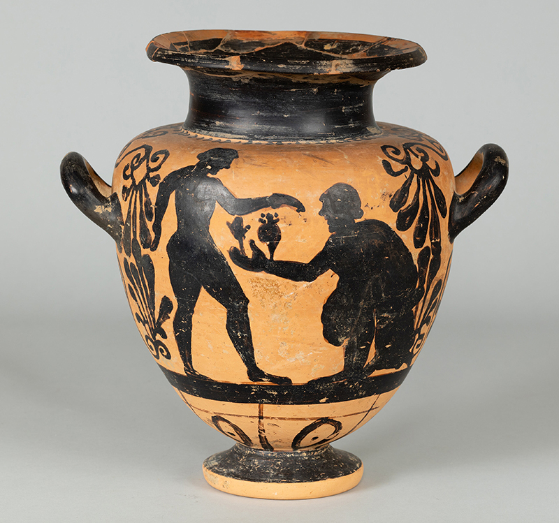 An ancient, footed container with two handles, and figures in black paint on a clay background