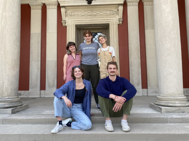 A group of 5 students posing together on the front steps of the BCMA