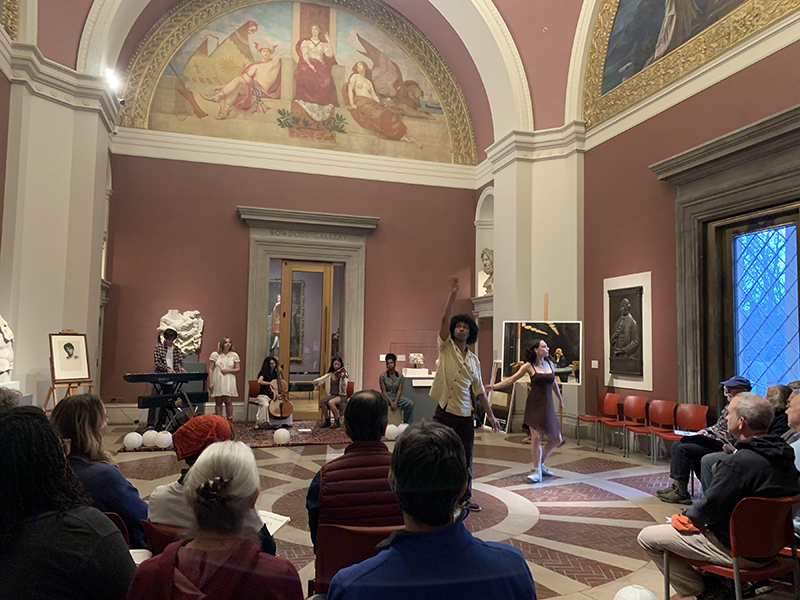 Musicians and dancers performing in the rotunda of a museum 