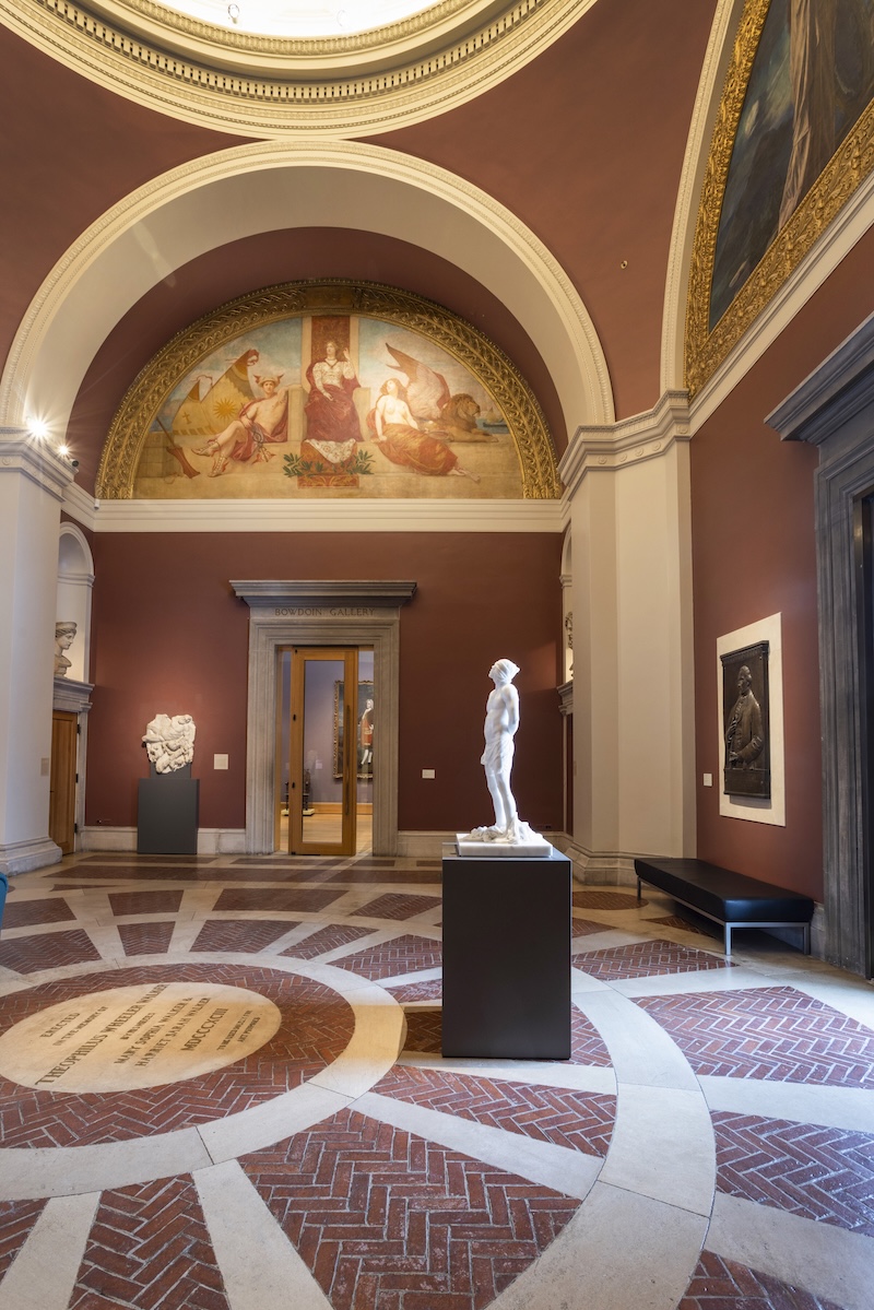 A freestanding marble sculpture displayed in an art museum