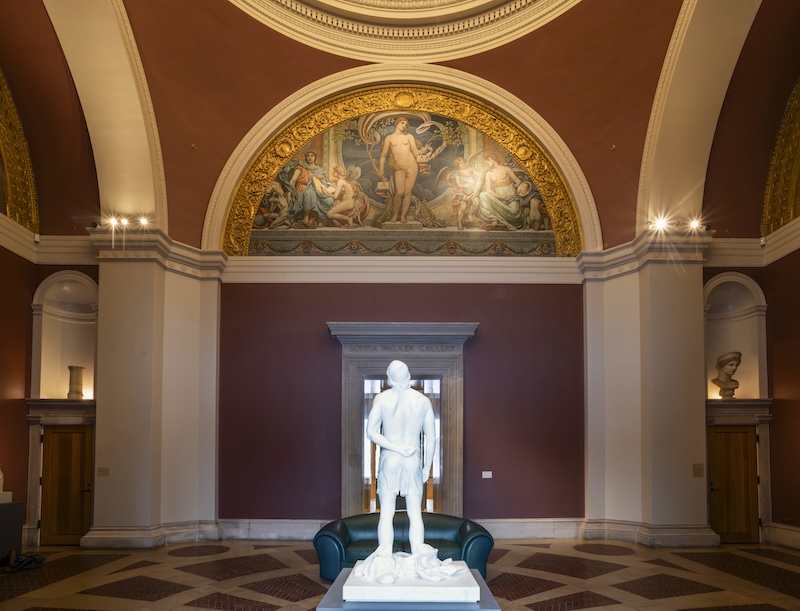 A freestanding marble sculpture displayed in an art museum