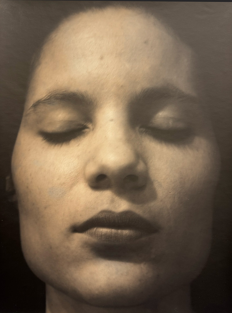 A black and white photograph of a close up portrait of a woman's face