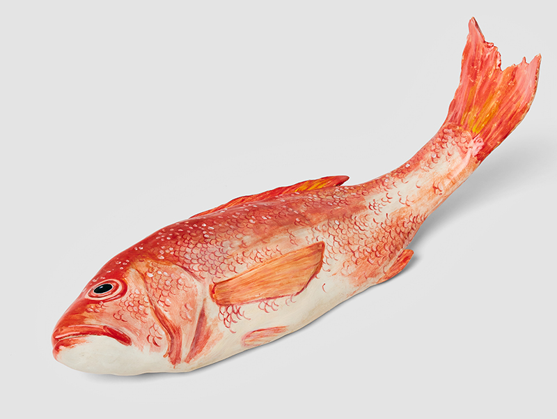 A ceramic sculpture of a red snapper fish