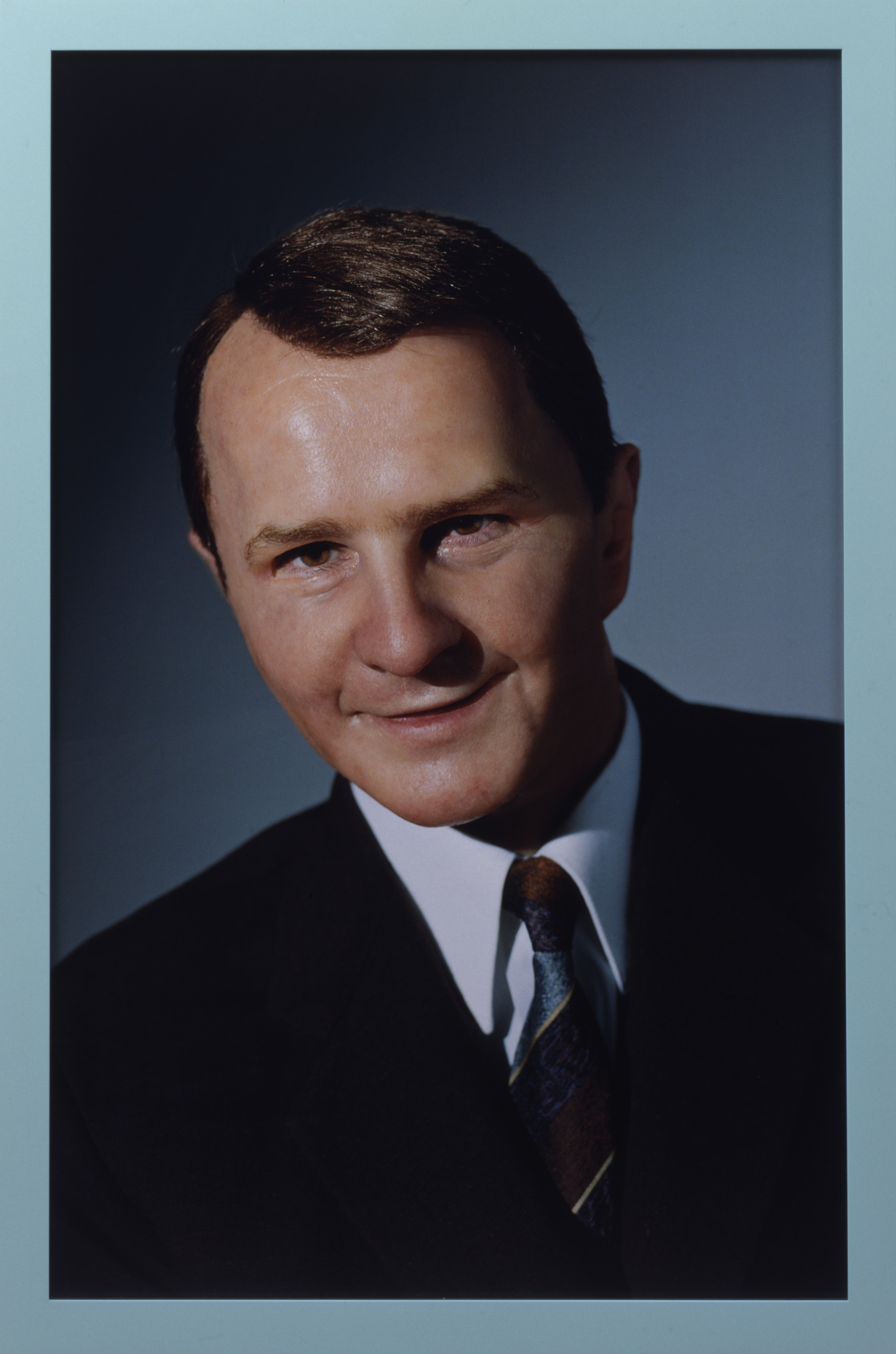 A photograph of a person in what appears to be a formal photographic headshot portrait
