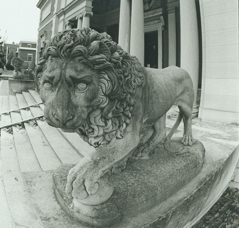 A black and white photo of exterior lion sculptures at an art museum