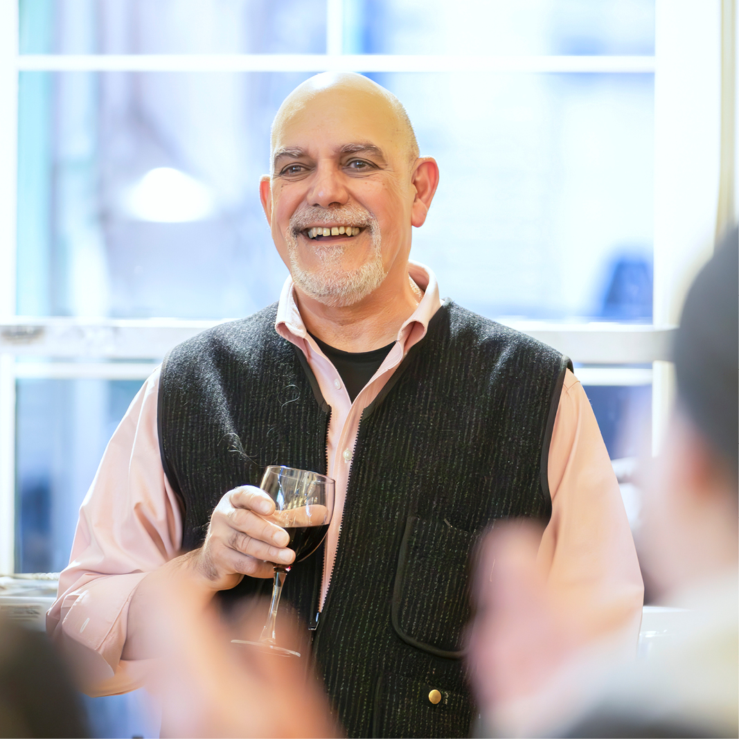 A photograph of a person smiling at a party