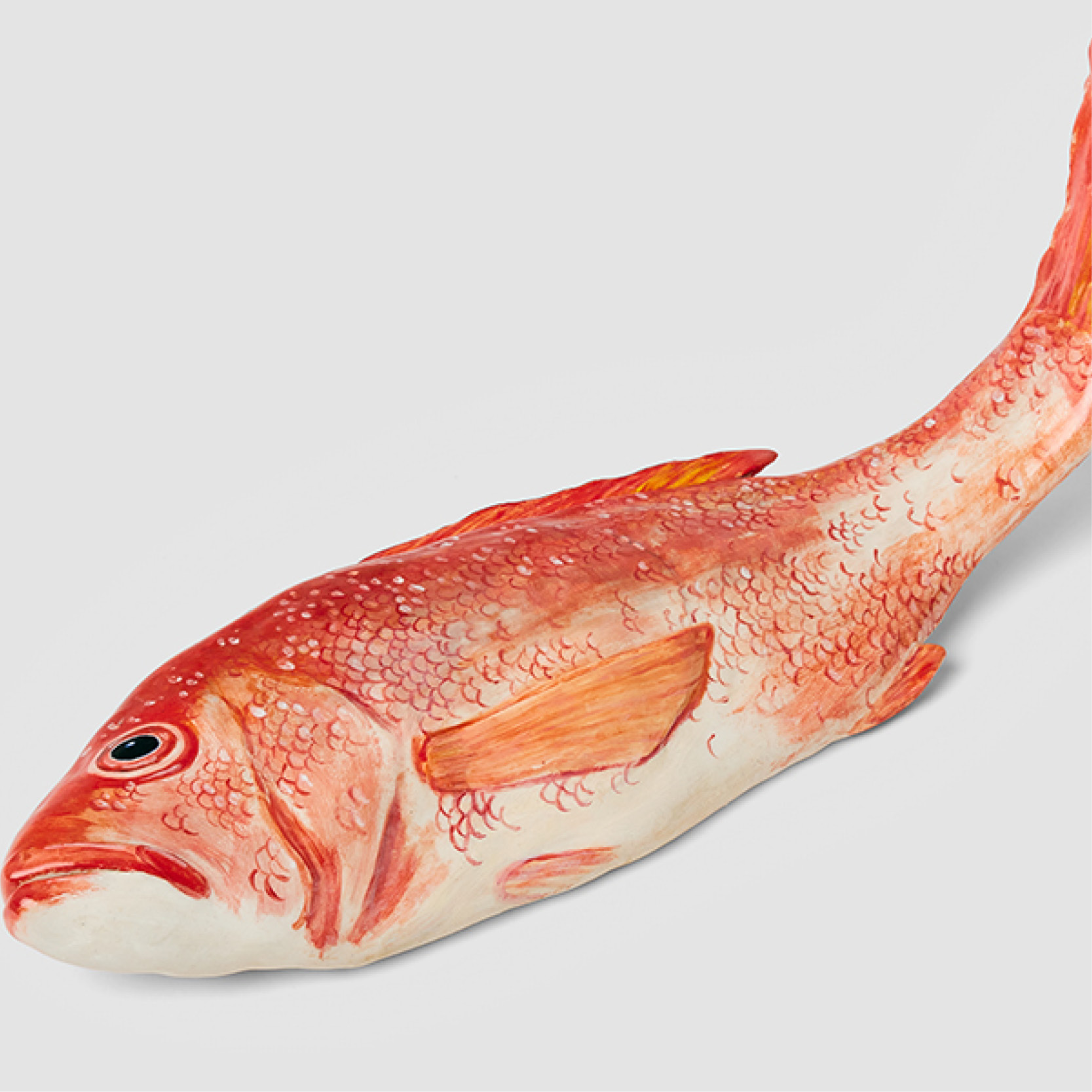 A ceramic sculpture of a red snapper fish