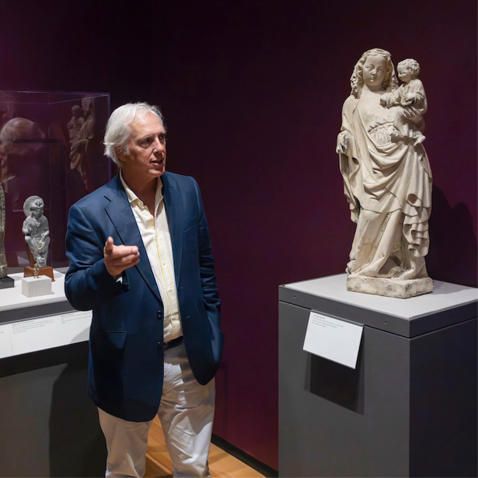 A person gives a tour of an exhibition of medieval art