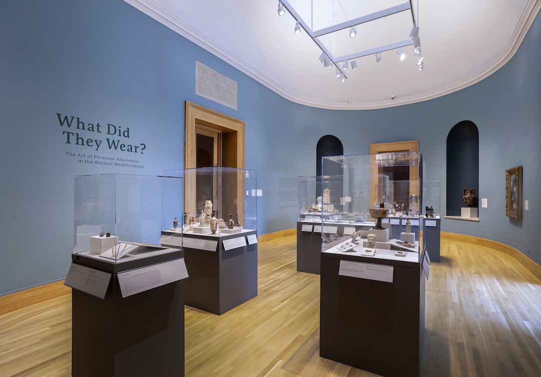 A museum exhibition with the title "What Did They Wear?" displayed