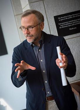 A headshot style photo of a person teaching