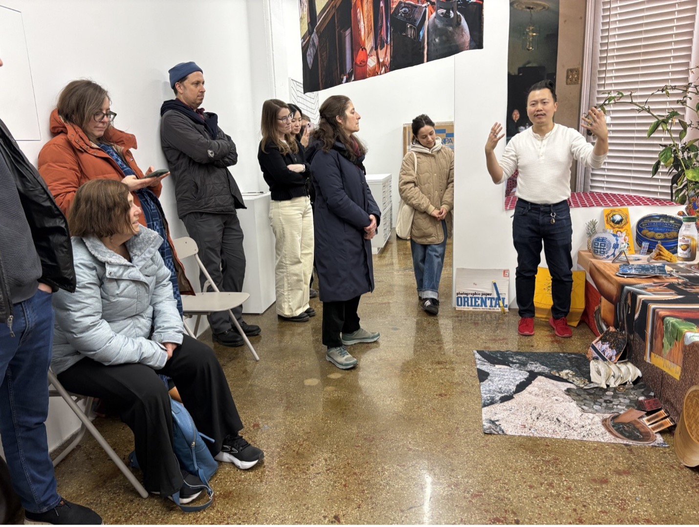 People listen to an artist speak about their work