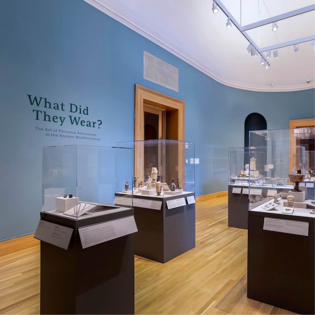 A museum exhibition with the title "What Did They Wear?" displayed