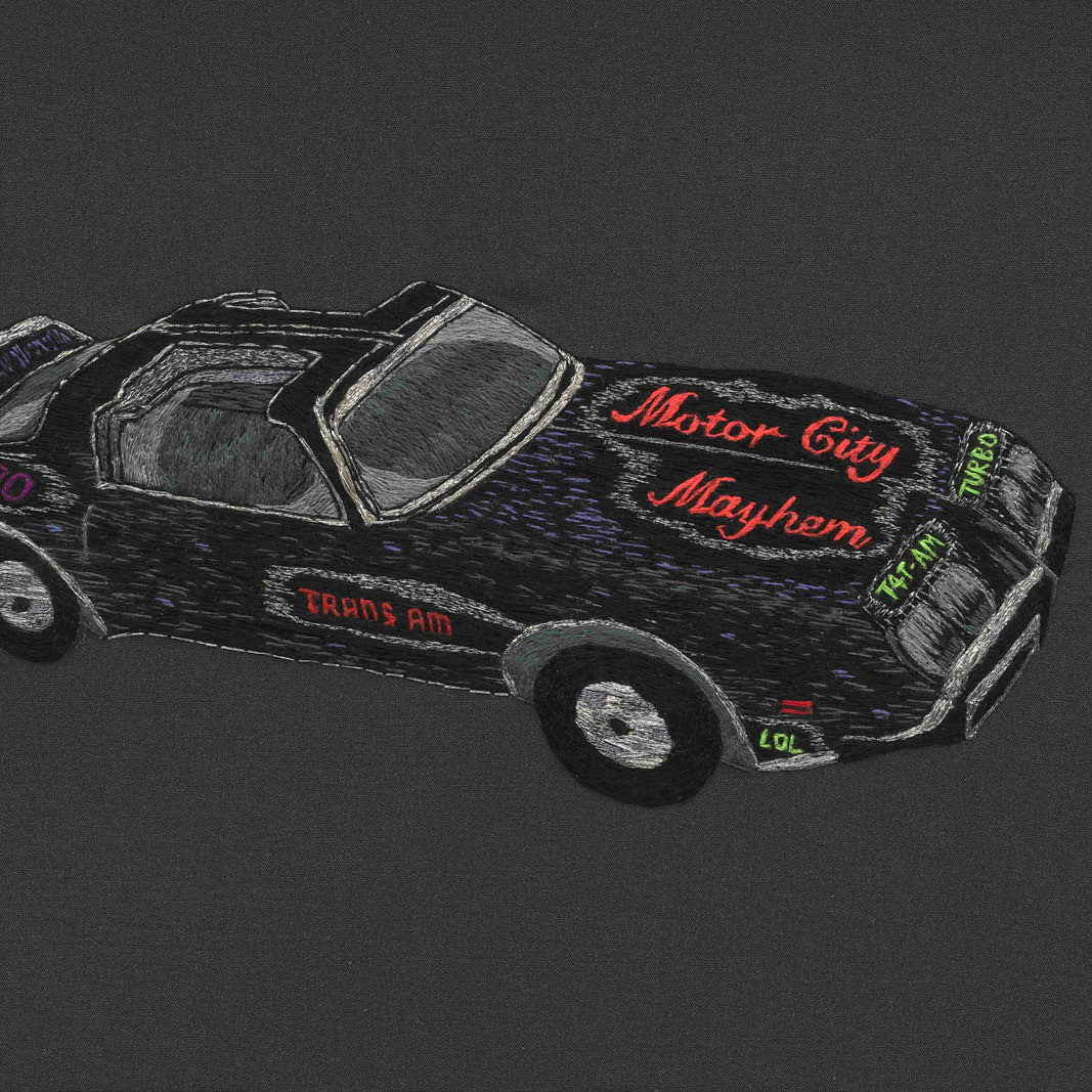 An embroidery depicting a vehicle with the words Motor City Mayhem
