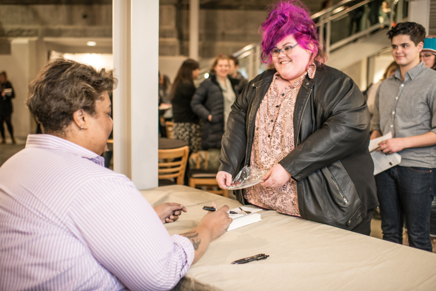 Students wait in line for autographs from visiting author Roxane Gay.