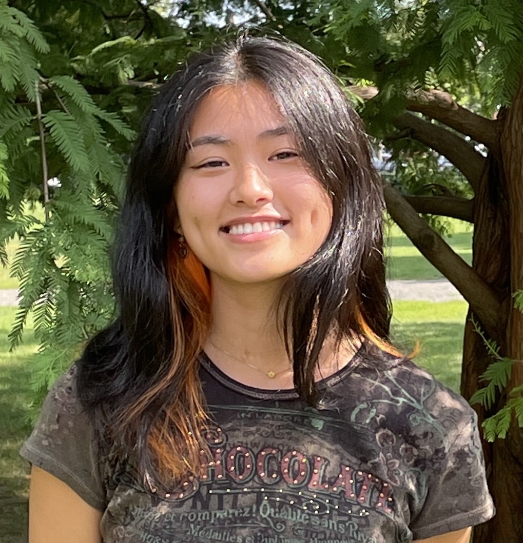 a headshot of Elisabeth Chan standing in front of trees
