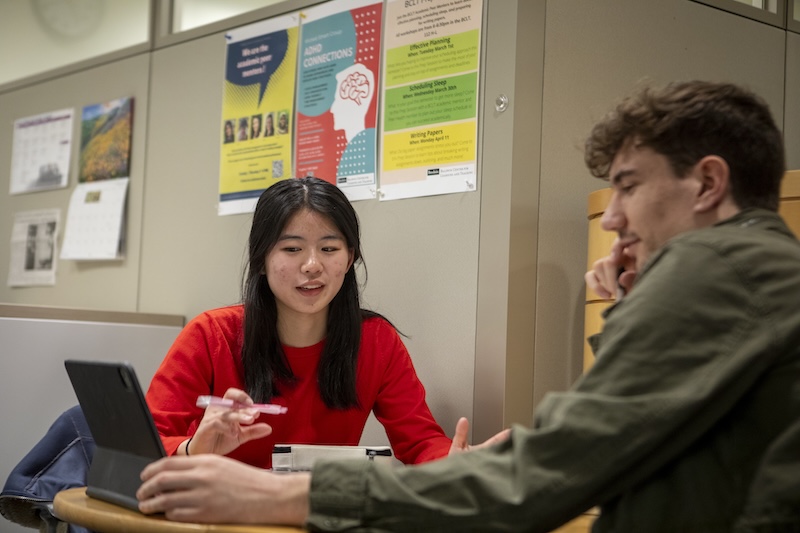 Two students chatting at a table