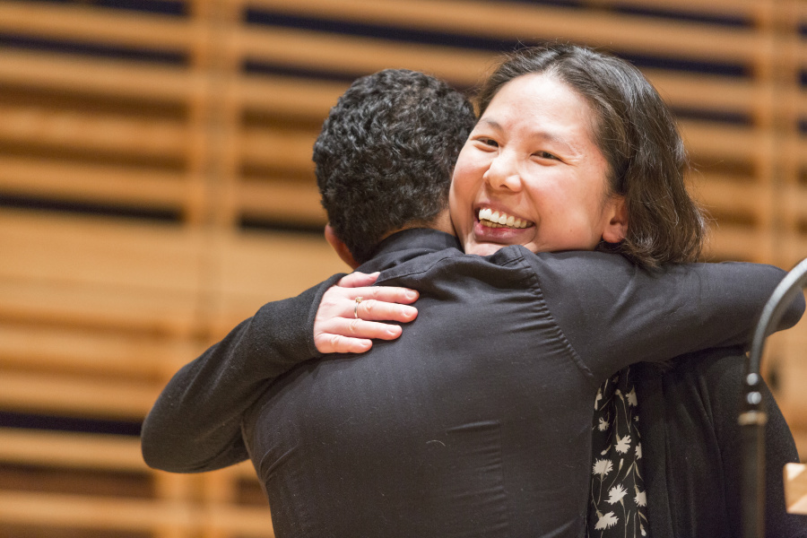 Students hug at Awards Ceremony