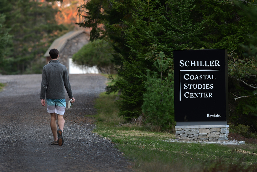 Schiller Coastal Studies sign with student walking