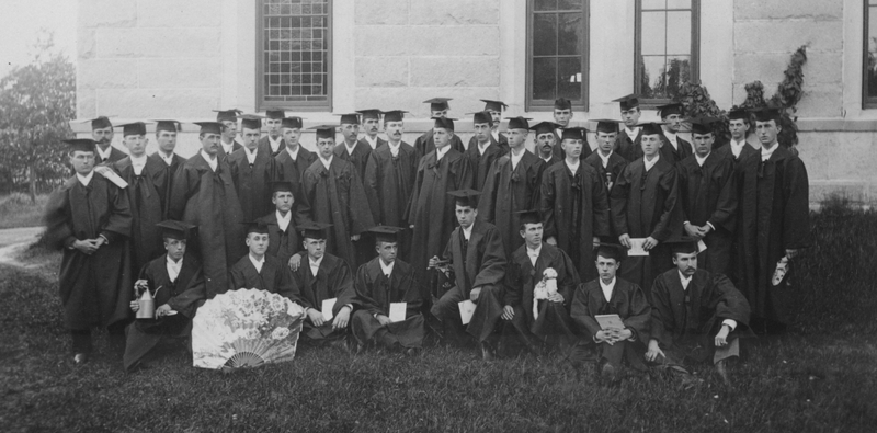 Black and white photo of a group of students in their cap and gowns