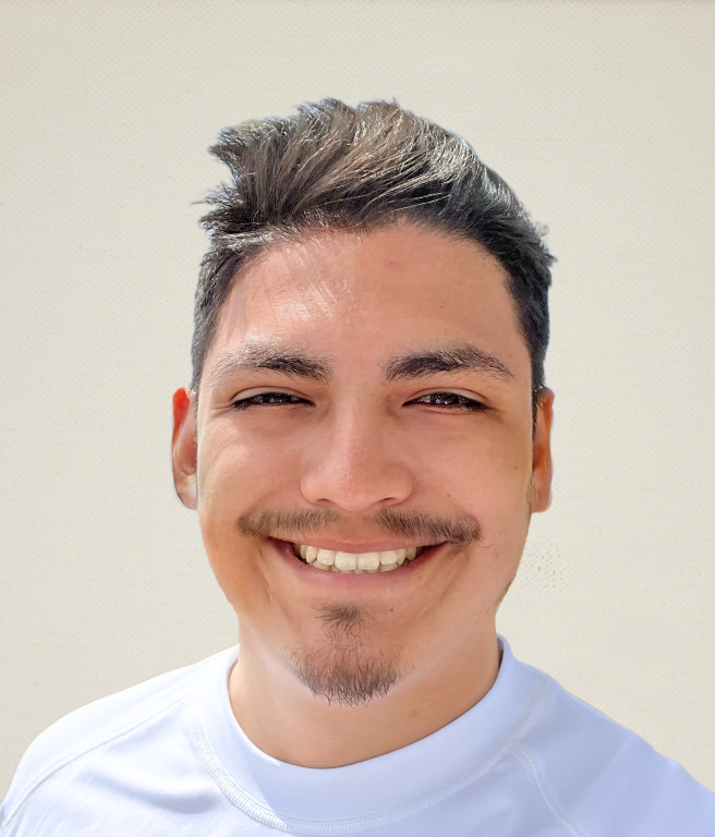 student in white T-shirt smiling