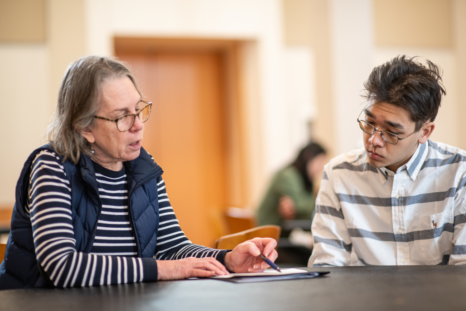 advisor nancy helps a student with his resume